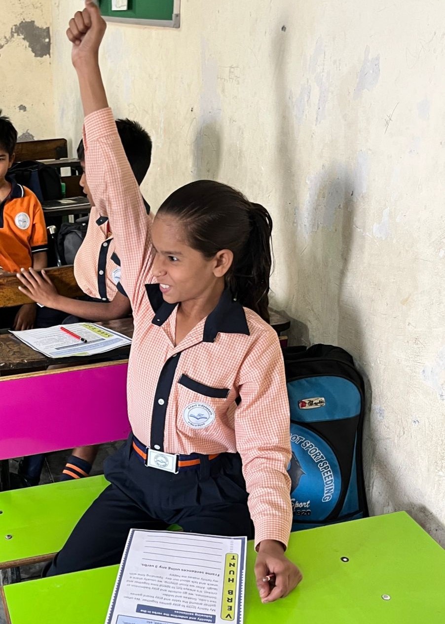 AVP school children reading books with teacher